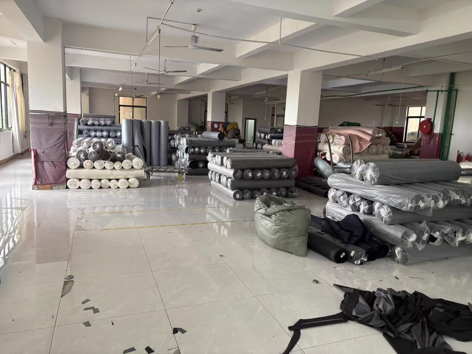Fabric rolls stored at the SunCheer puffer jacket factory