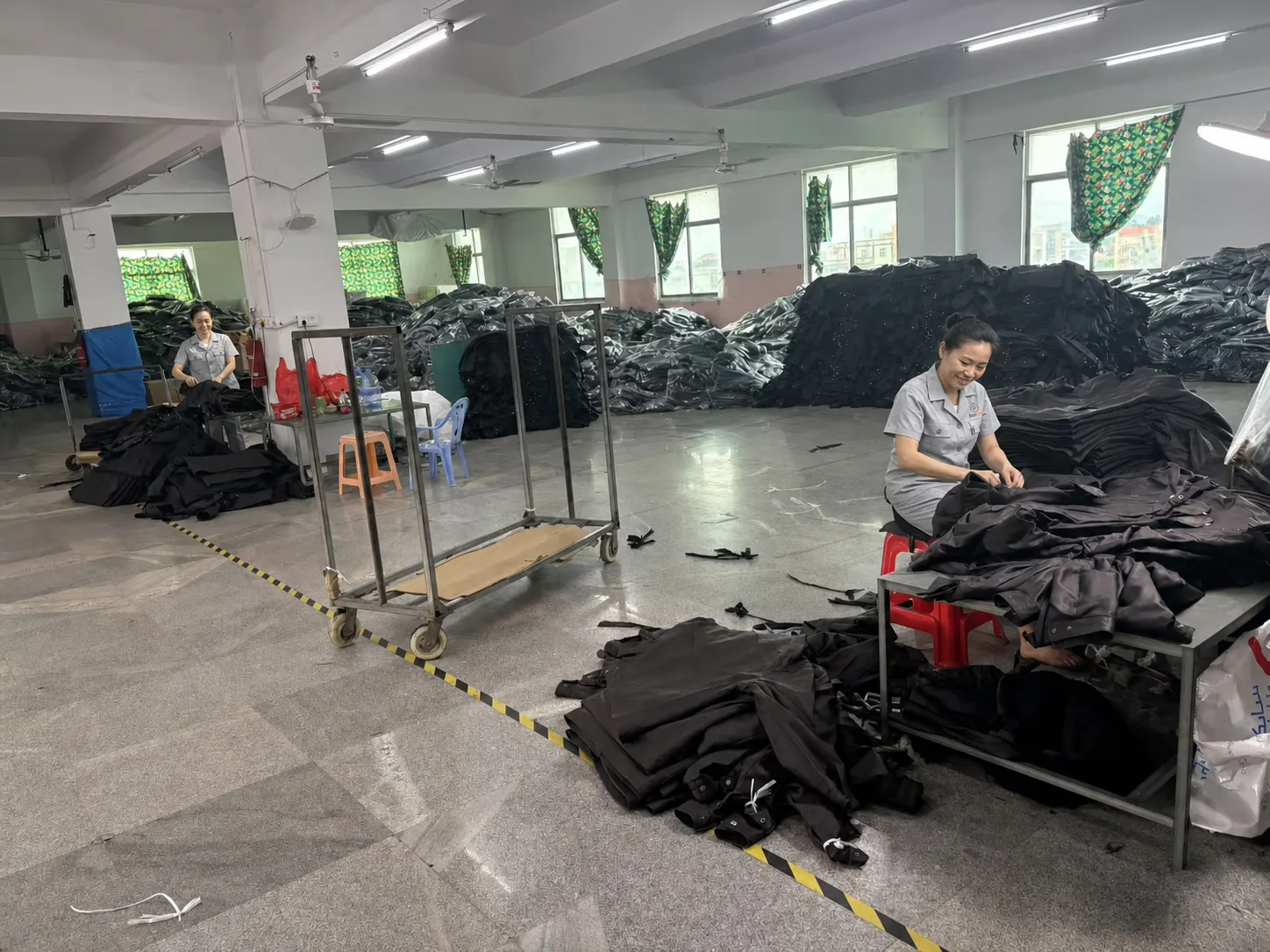 SunCheer staff carrying out visual checks on puffer jacket production