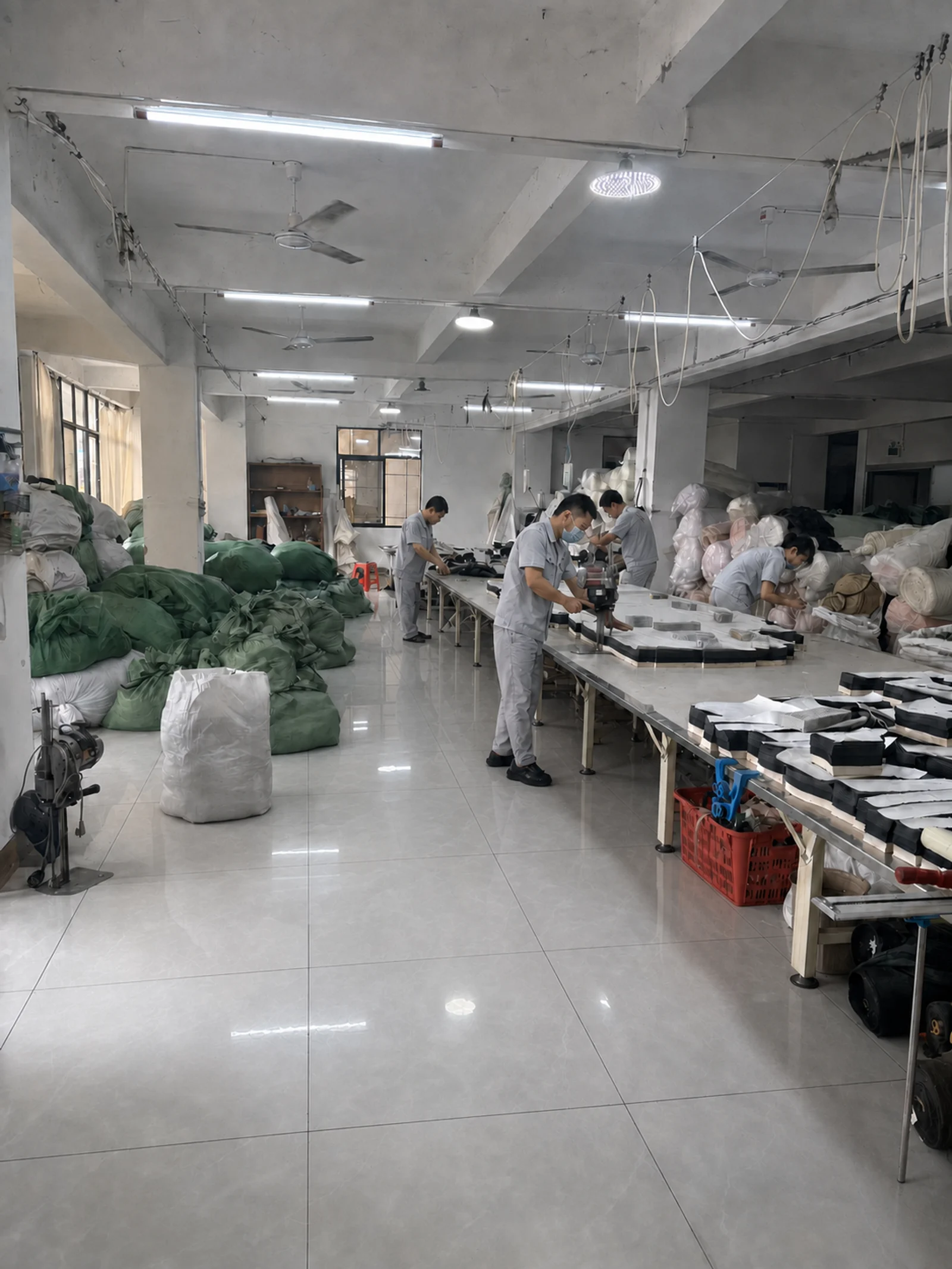SunCheer workers cutting fabric components for puffer jacket samples